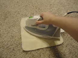 hold iron on cloth until steam penetrates, keep checking for stain transfer 